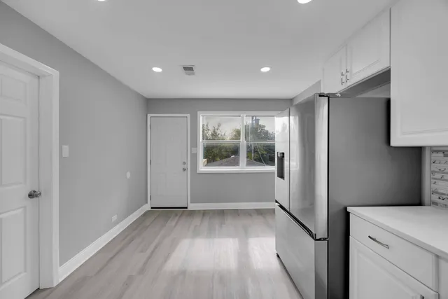 a view of a big room with wooden floor and windows
