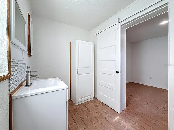 a room with a sink cabinets and a window