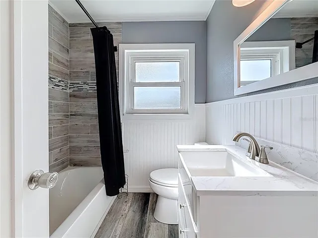 a bathroom with a sink toilet and mirror