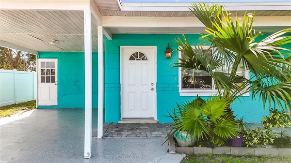 a front view of a house with a tree