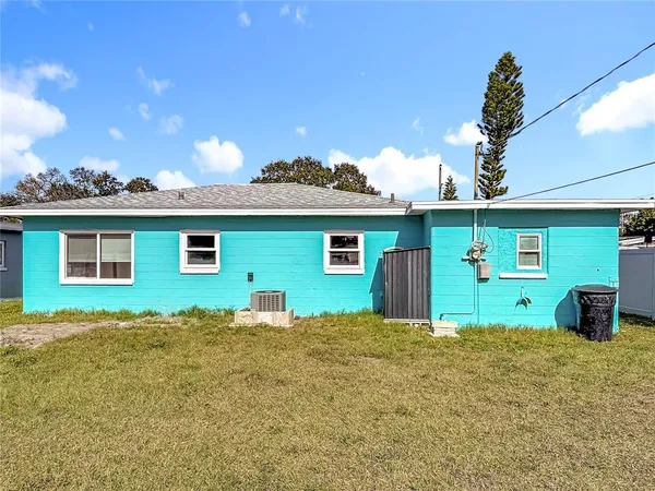 an aerial view of a house with swimming pool patio and outdoor seating