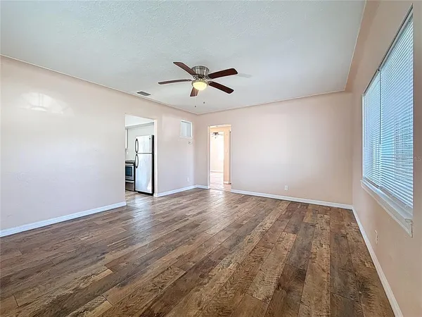 wooden floor in an empty room with a window