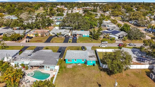 a front view of a house with a garden and lake view