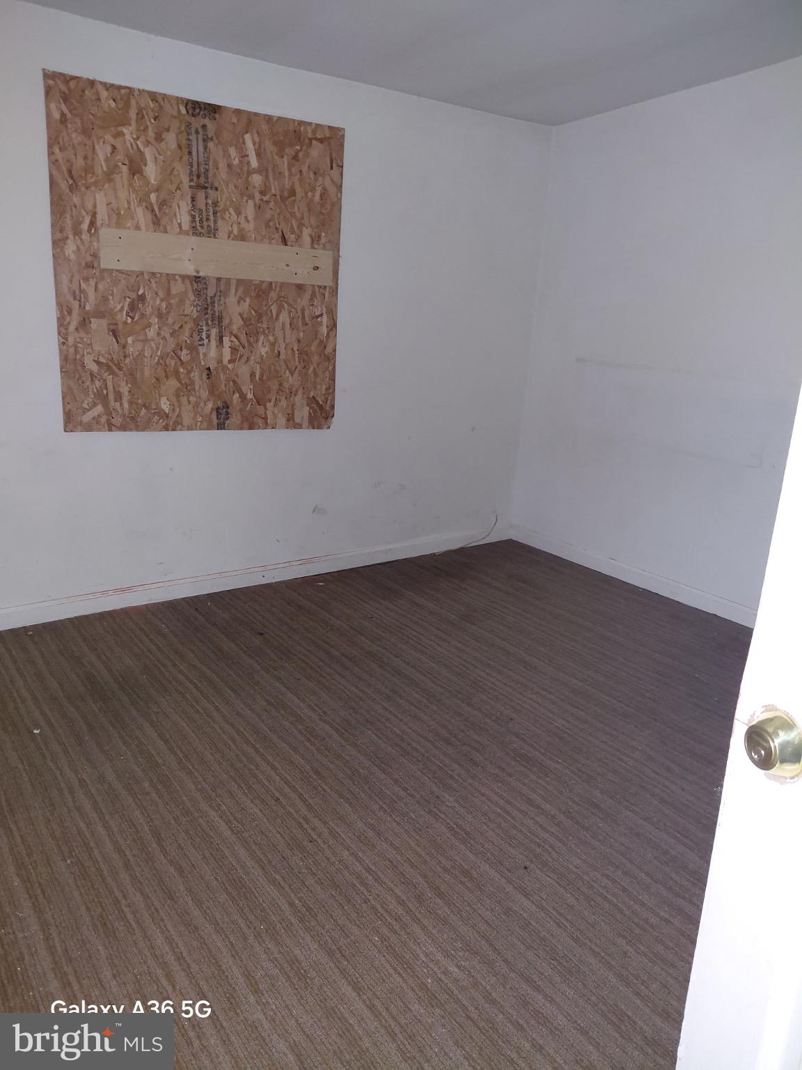 2328 Nicholson Street Southeast Washington, DC 20020 - Photo 14 of 26 an empty room with wooden floor and windows
