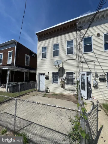 a view of a house with wooden fence