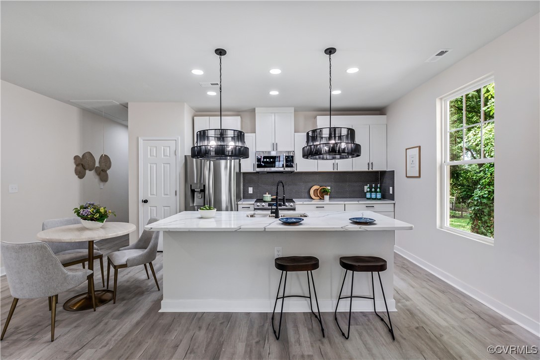1125 Rome Street Petersburg, VA 23803 - Photo 13 of 38 Kitchen with backsplash, sink, light hardwood / wo