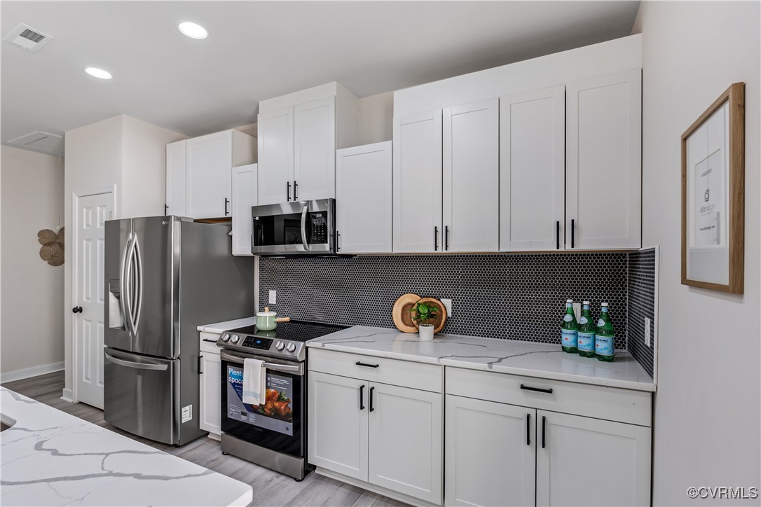 1125 Rome Street Petersburg, VA 23803 - Photo 14 of 38 Kitchen with tasteful backsplash, white cabinetry,