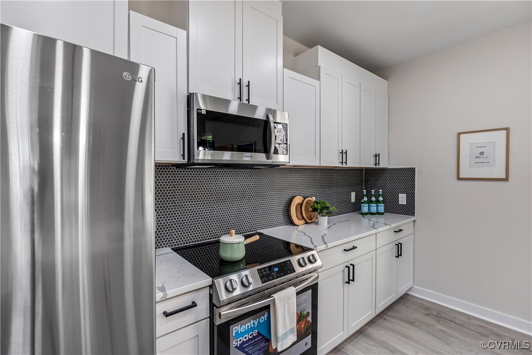 1125 Rome Street Petersburg, VA 23803 - Photo 17 of 38 Kitchen featuring decorative backsplash, light har