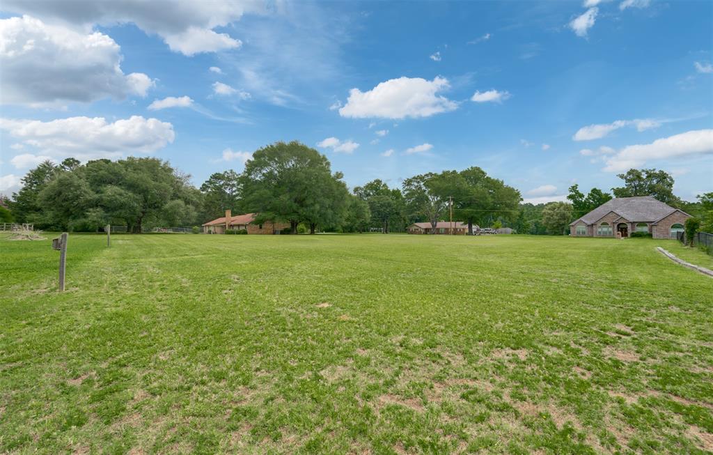 8798 Hill N Dale Road Tyler, TX 75709 - Photo 30 of 31 Expansive grassy area with lush trees bordering the property