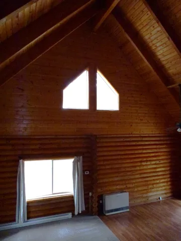 a view of room with a window and wooden floor