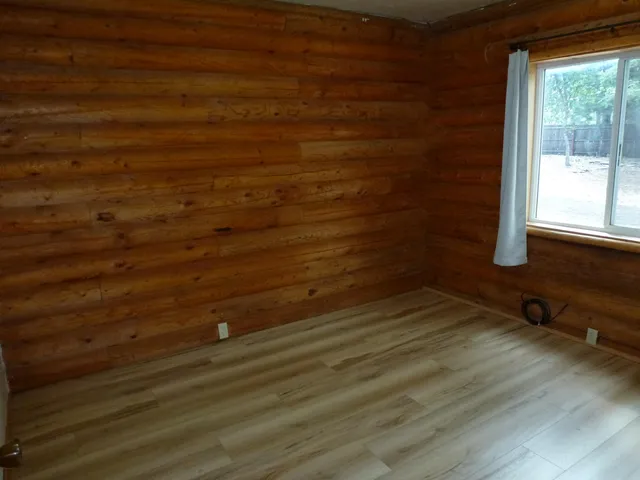 a view of a livingroom with an empty space and a window