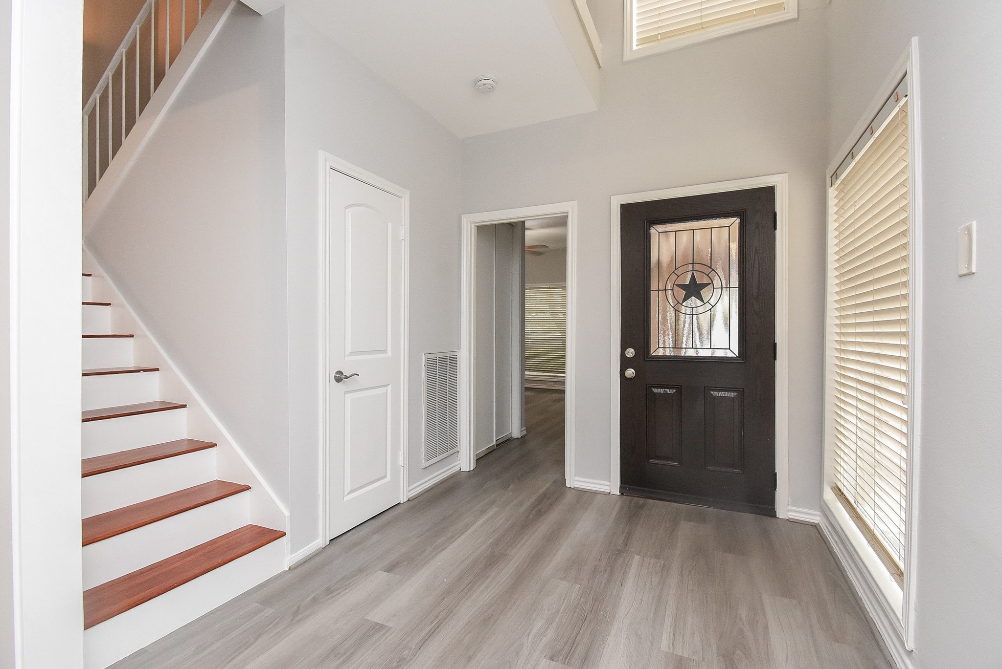 201 Vanderpool Lane, Unit 113 Houston, TX 77024 - Photo 3 of 45 a view of a livingroom with wooden floor and stairs