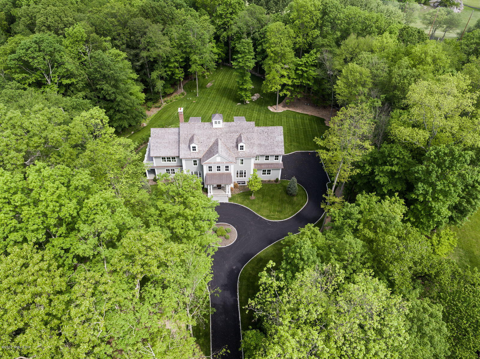49 Byfield Lane Greenwich, CT 06830 - Photo 14 of 14 an aerial view of a house with a yard and trees all around