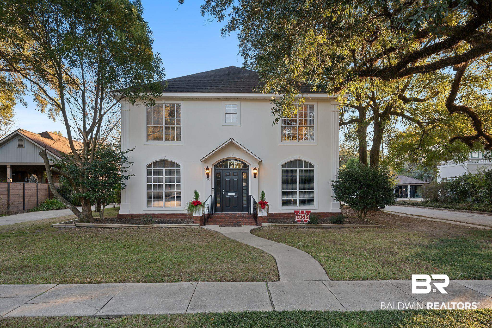 1825 Spring Hill Avenue Mobile, AL 36607 - Photo 1 of 43 View of front facade with a front lawn and stucco siding