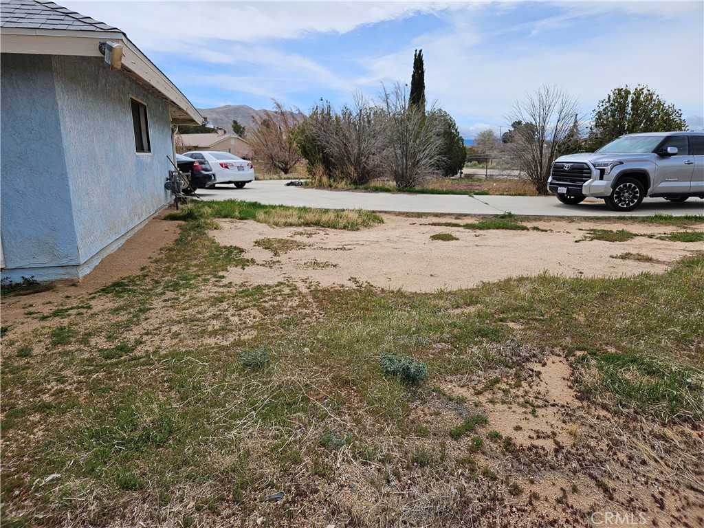 11175 Tyee Road Apple Valley, CA 92308 - Photo 13 of 31 a view of a yard with car parked
