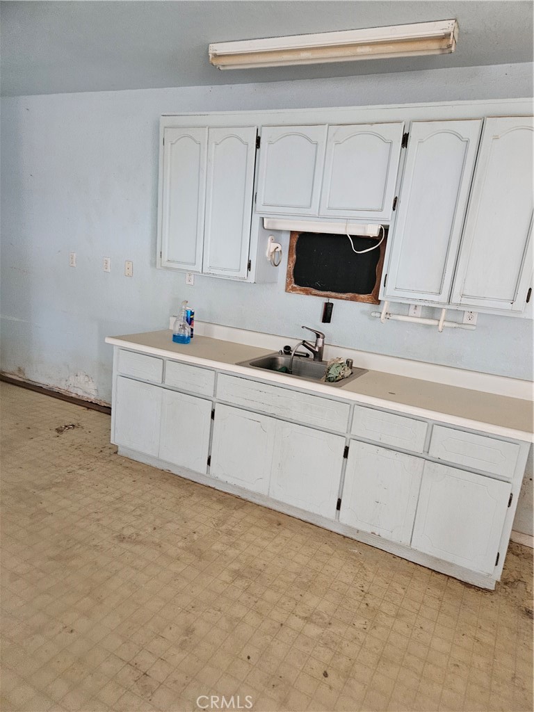 11175 Tyee Road Apple Valley, CA 92308 - Photo 18 of 31 a kitchen with white cabinets