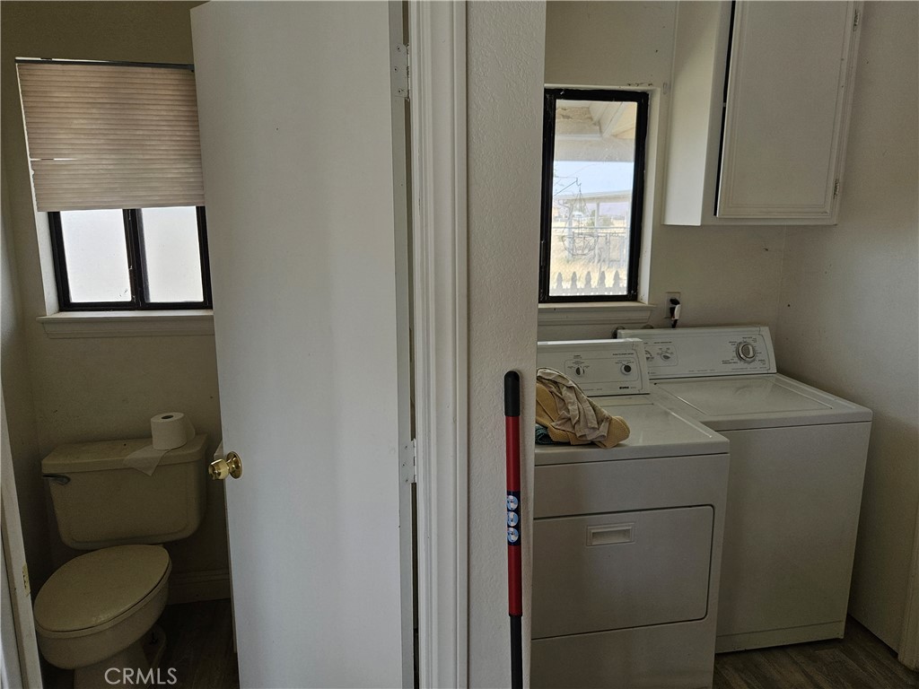 11175 Tyee Road Apple Valley, CA 92308 - Photo 30 of 31 a bathroom with a toilet sink and mirror