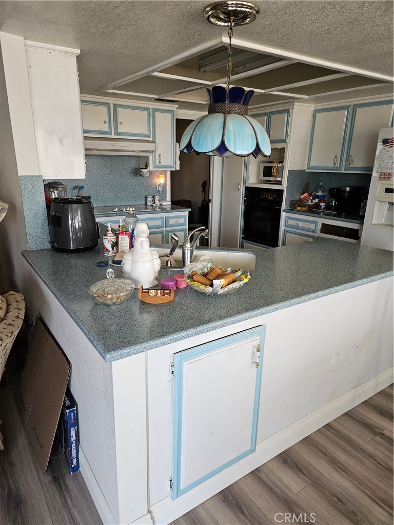 11175 Tyee Road Apple Valley, CA 92308 - Photo 3 of 31 a kitchen with stainless steel appliances granite countertop a sink a stove and a microwave