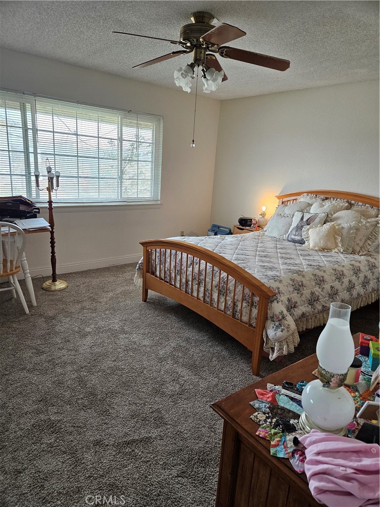 11175 Tyee Road Apple Valley, CA 92308 - Photo 6 of 31 a bedroom with furniture and a window