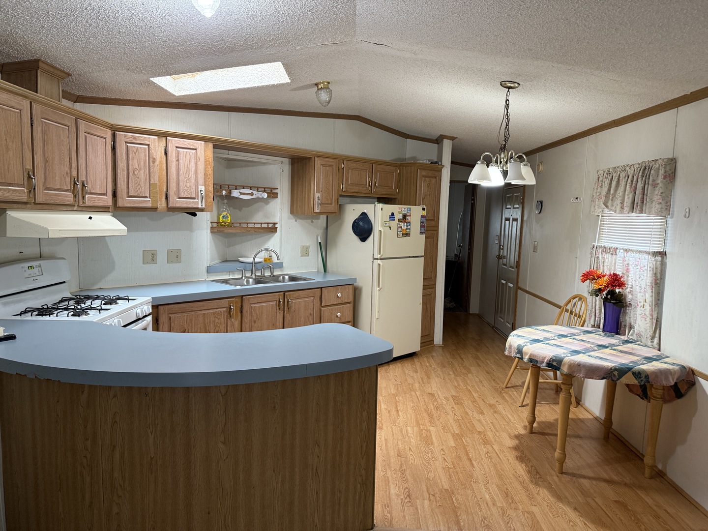 17 Cardinal Drive Beecher, IL 60401 - Photo 14 of 17 a kitchen with stainless steel appliances granite countertop a refrigerator a sink dishwasher a dining table and chairs with wooden floor