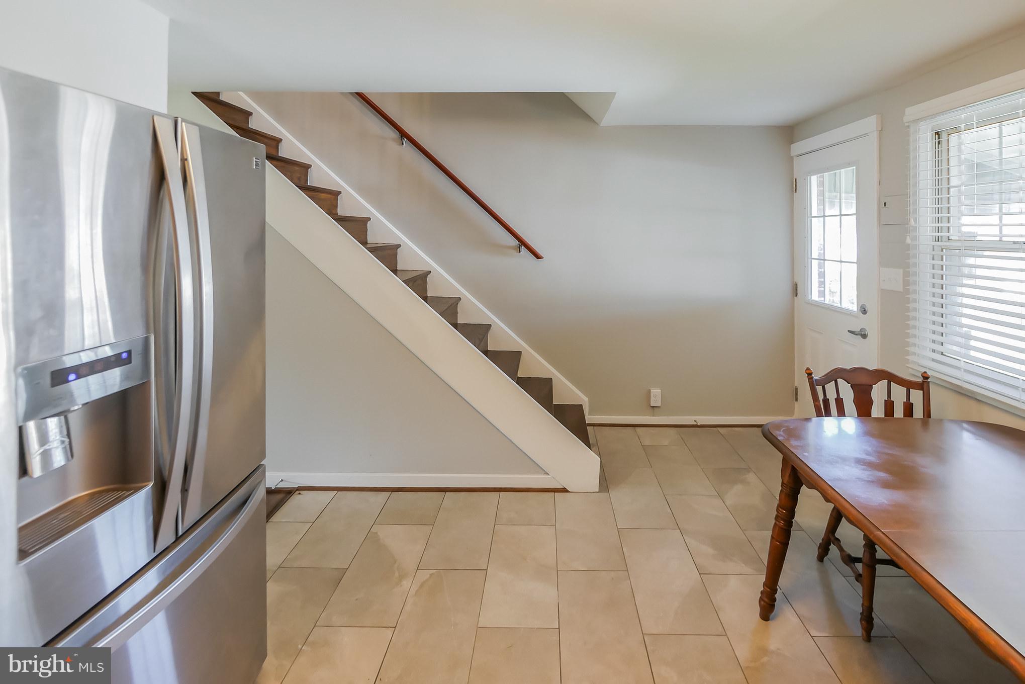4410 Annapolis Road Baltimore, MD 21227 - Photo 13 of 31 a view of a hardwood floor and staircase in a room