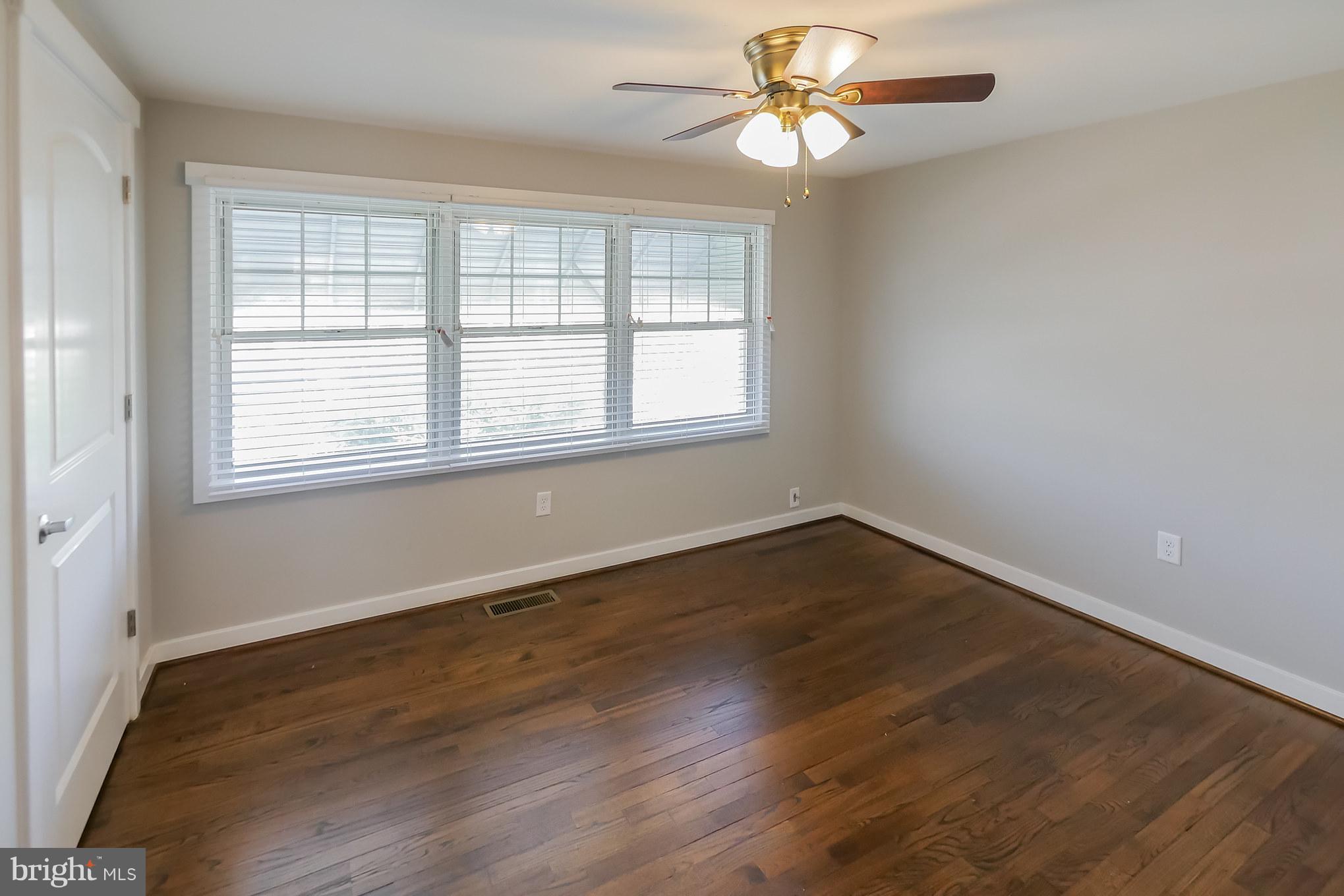 4410 Annapolis Road Baltimore, MD 21227 - Photo 16 of 31 a view of an empty room with wooden floor and a window