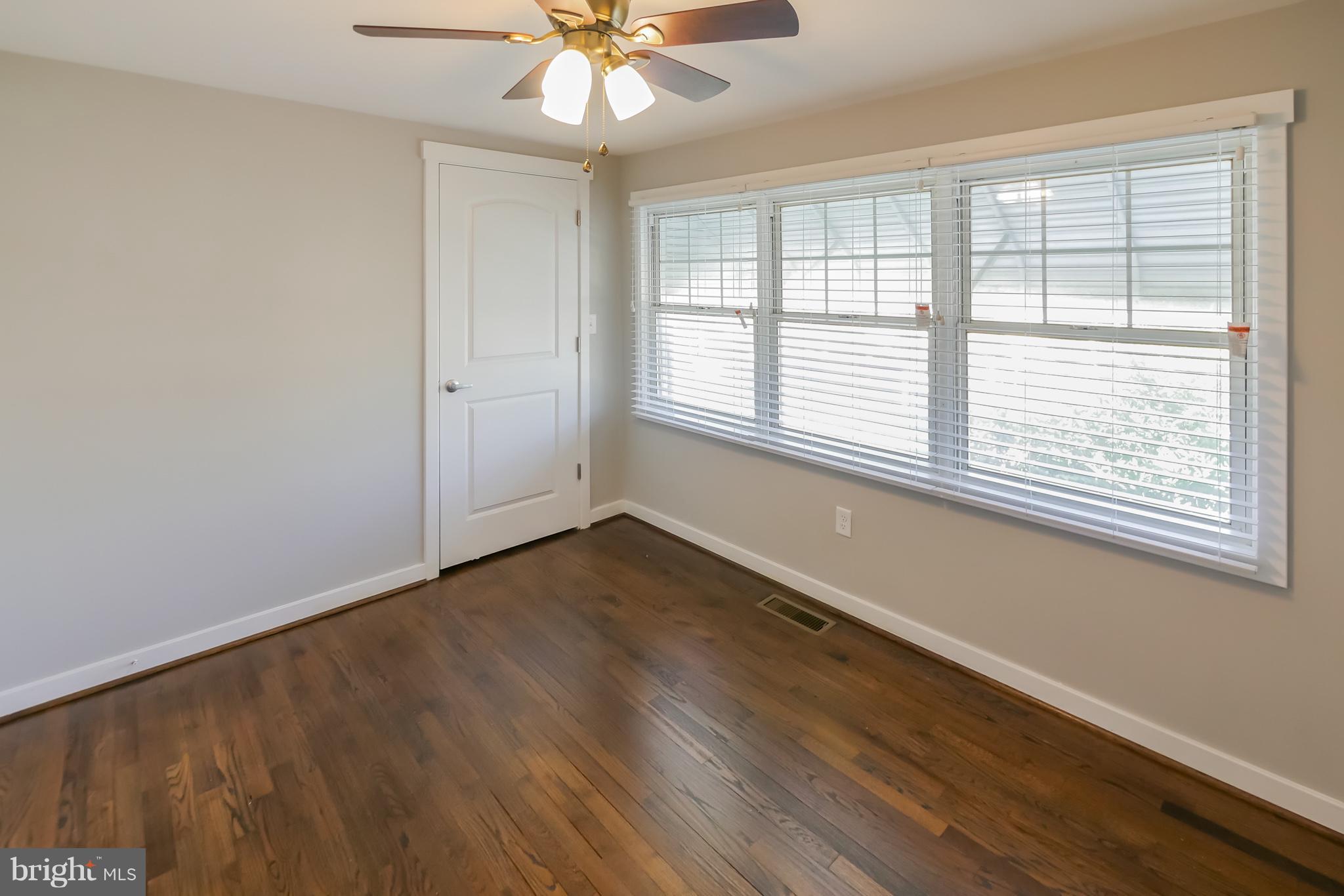 4410 Annapolis Road Baltimore, MD 21227 - Photo 17 of 31 a view of an empty room with a window and wooden floor