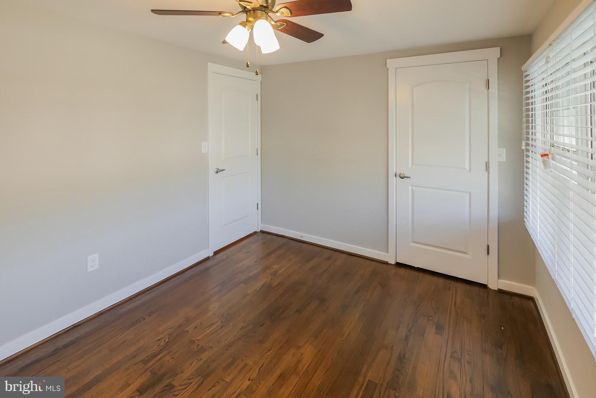 4410 Annapolis Road Baltimore, MD 21227 - Photo 18 of 31 wooden floor in an empty room with a window