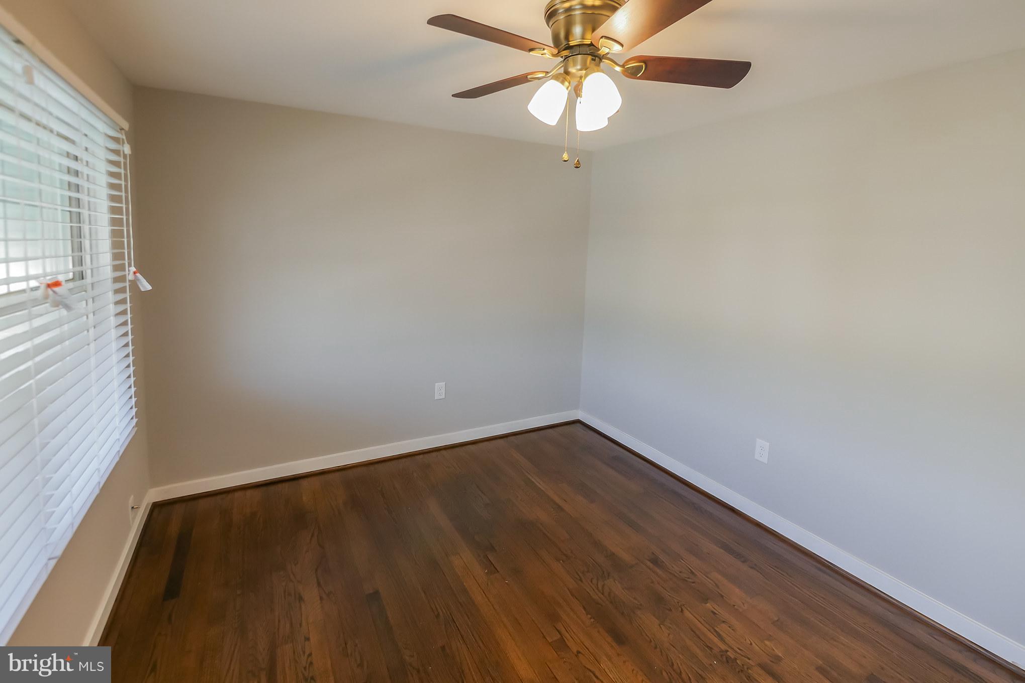 4410 Annapolis Road Baltimore, MD 21227 - Photo 19 of 31 an empty room with a window and a fan