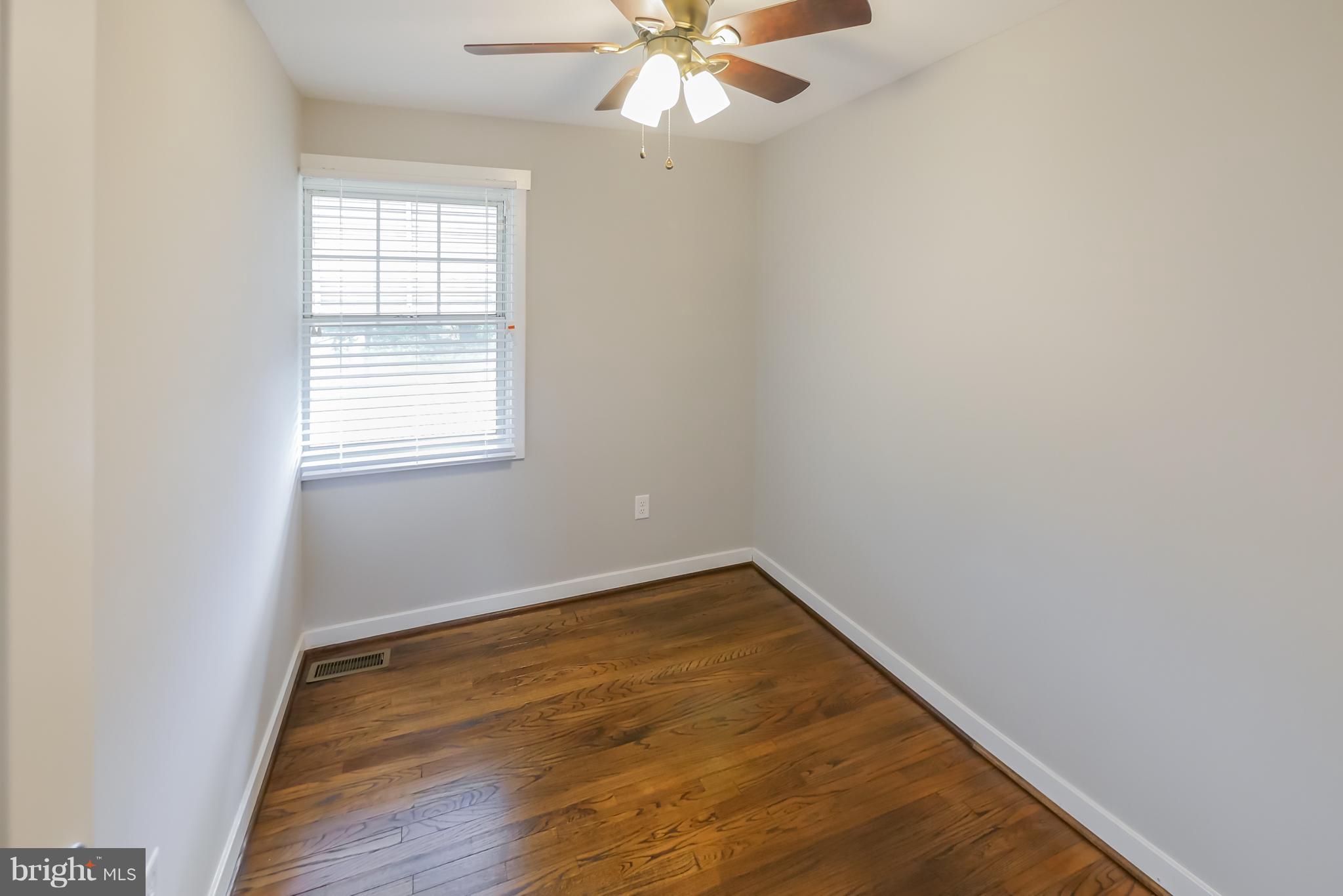 4410 Annapolis Road Baltimore, MD 21227 - Photo 20 of 31 an empty room with a window and a fan