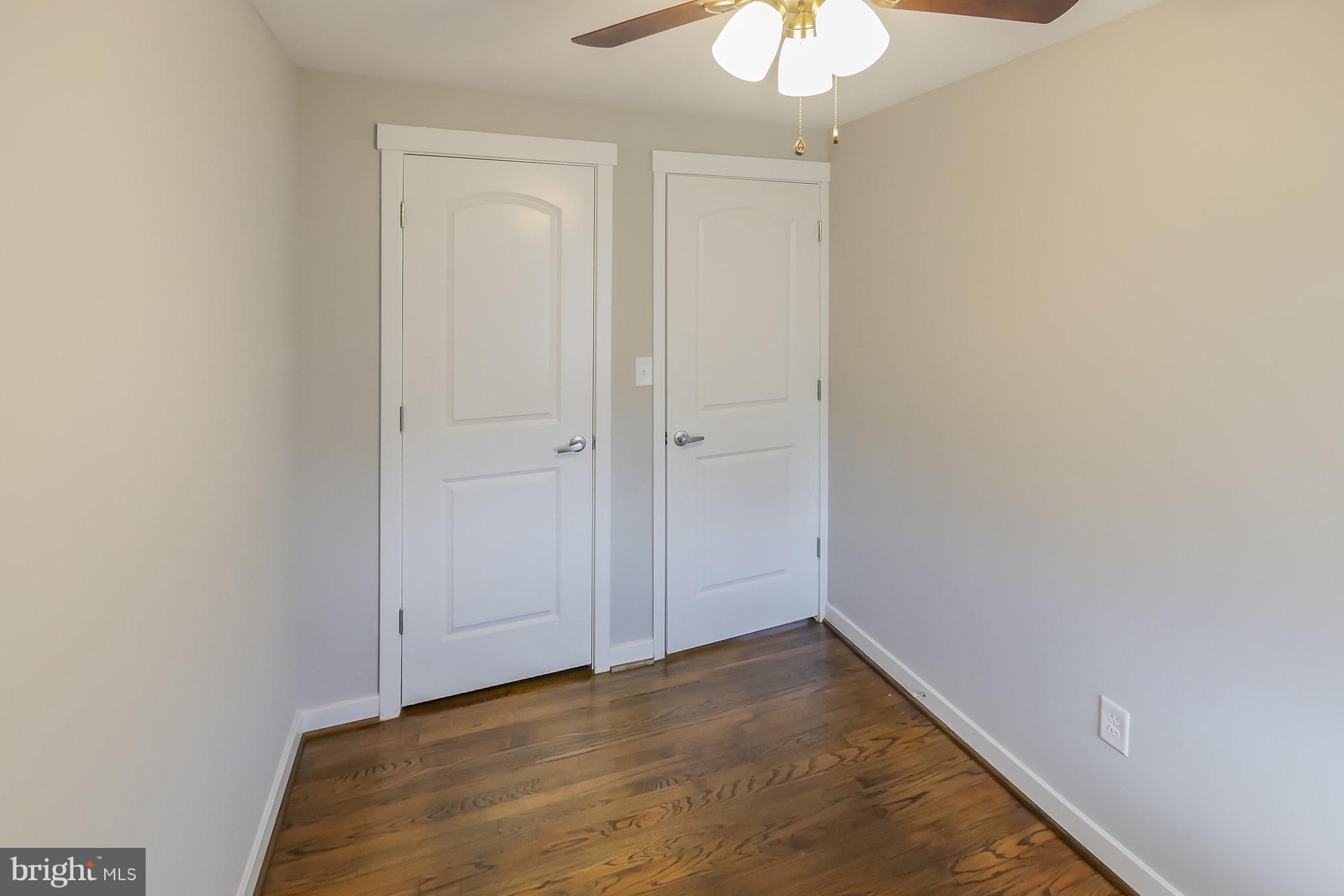 4410 Annapolis Road Baltimore, MD 21227 - Photo 21 of 31 an empty room with a chandelier fan