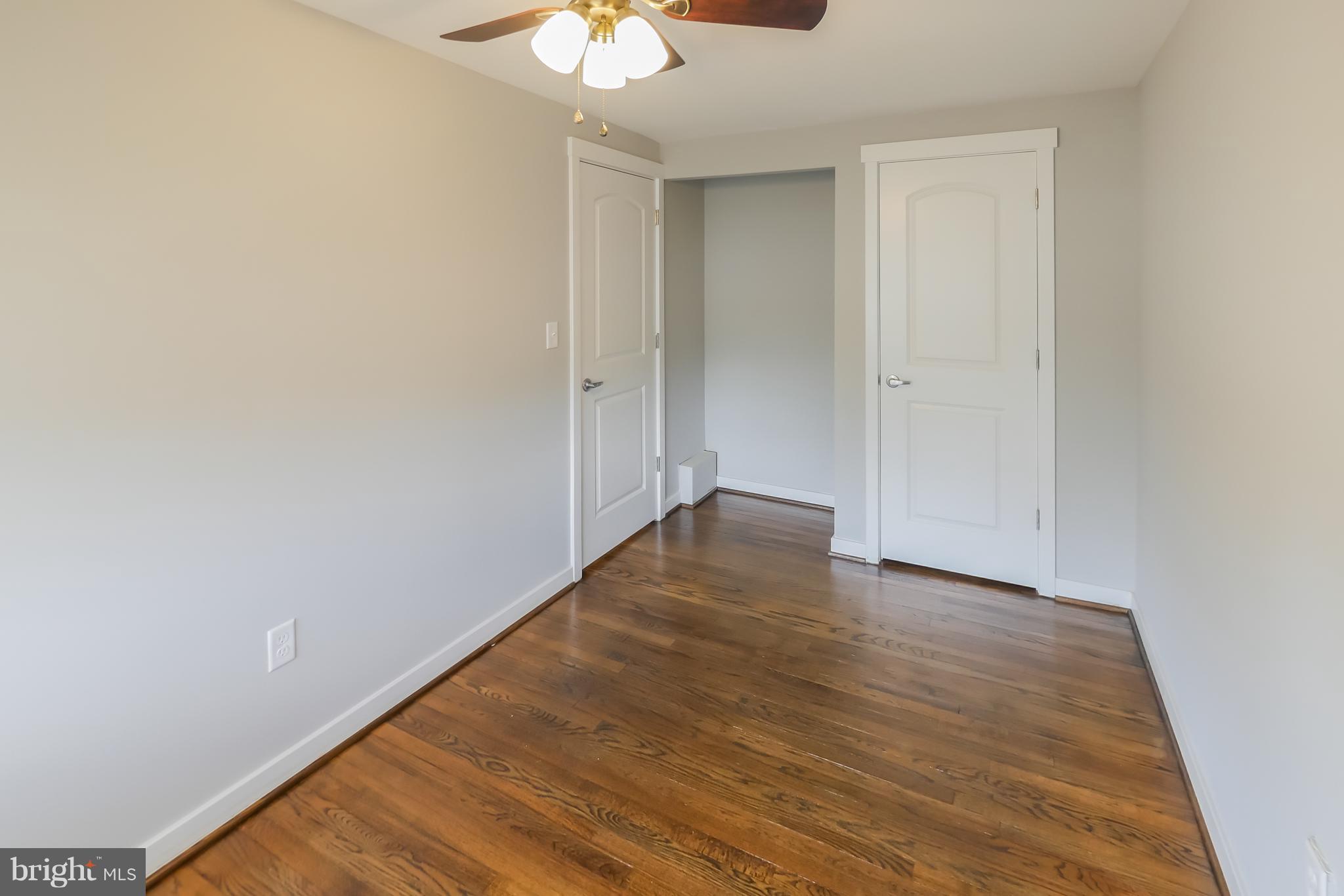 4410 Annapolis Road Baltimore, MD 21227 - Photo 23 of 31 a view of an empty room with a chandelier fan