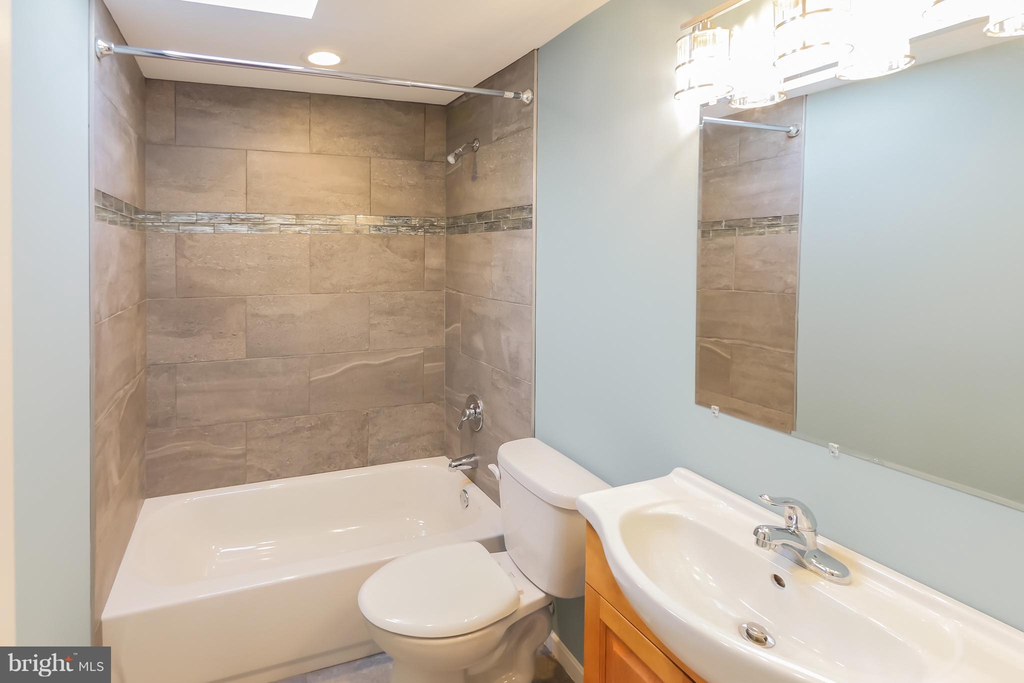 4410 Annapolis Road Baltimore, MD 21227 - Photo 24 of 31 a bathroom with a toilet a sink and bathtub
