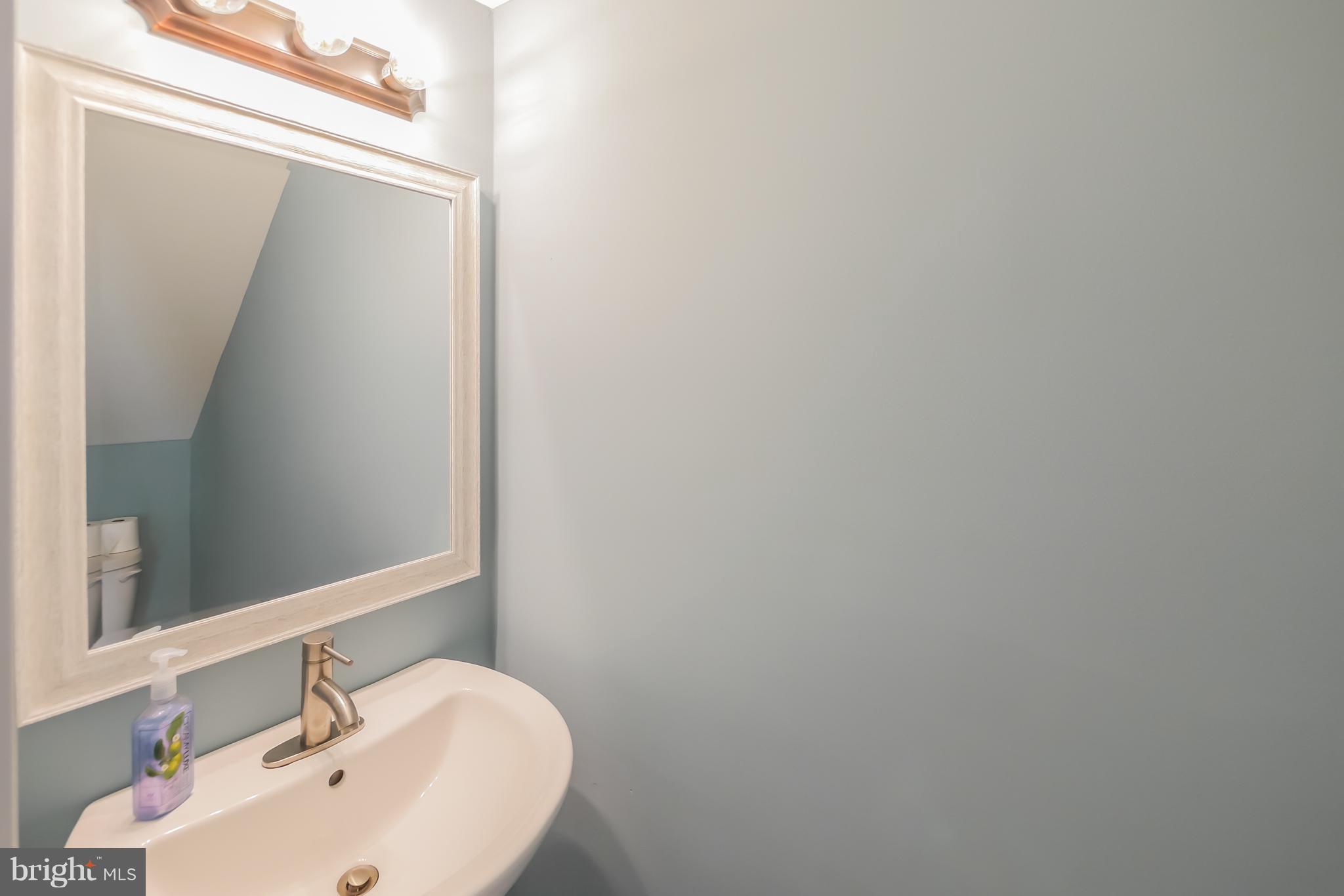 4410 Annapolis Road Baltimore, MD 21227 - Photo 6 of 31 a bathroom with a sink and mirror