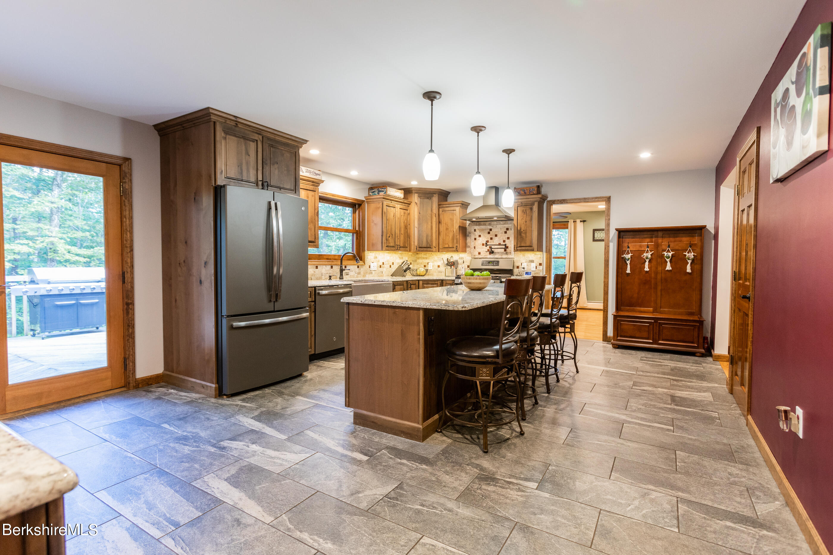 1191 South Washington State Road Washington, MA 01223 - Photo 7 of 41 a kitchen with stainless steel appliances granite countertop a refrigerator a stove a sink a dining table and chairs with the wooden floor