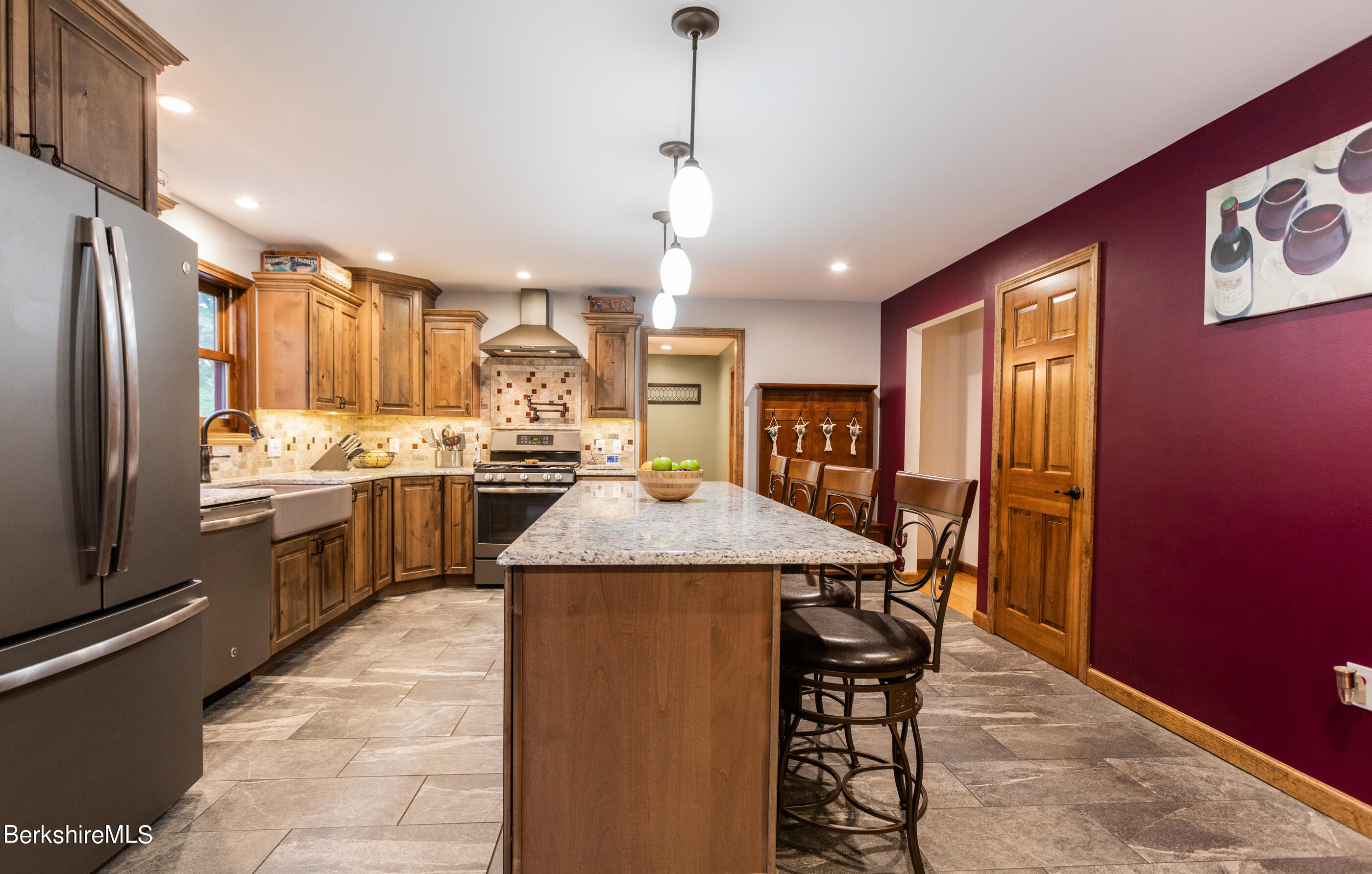 1191 South Washington State Road Washington, MA 01223 - Photo 8 of 41 a kitchen with stainless steel appliances kitchen island granite countertop a refrigerator a sink dishwasher a stove and a dining table with wooden floor