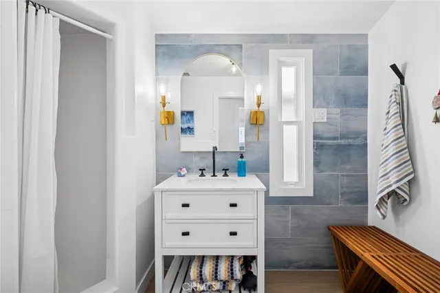 a bathroom with a sink a mirror and a shower