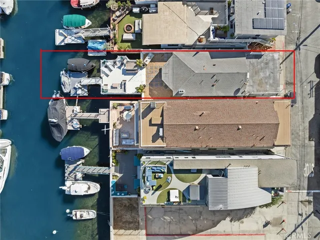 a view of a white building with potted plants