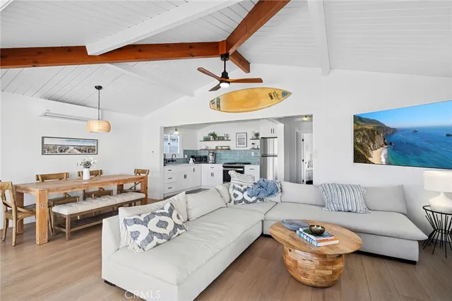 a living room with furniture and kitchen view