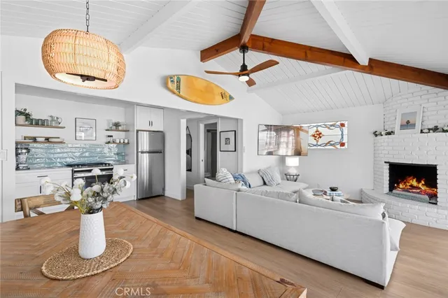a living room with fireplace furniture and a chandelier