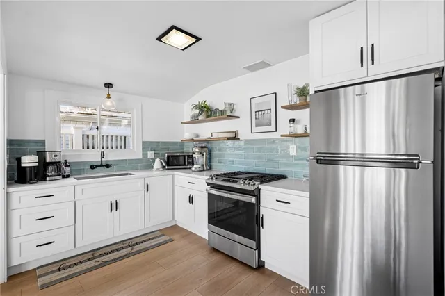 a kitchen with granite countertop white cabinets and white appliances