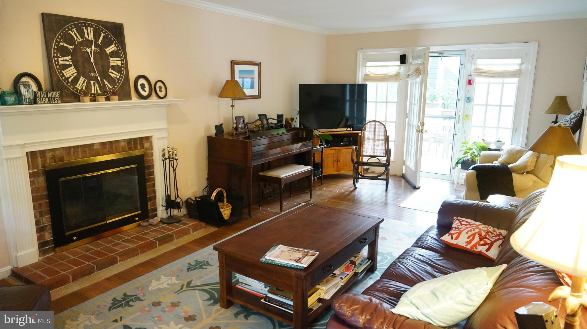 2117 Salt Kettle Way Reston, VA 20191 - Photo 6 of 30 a living room with furniture a fireplace and a flat screen tv