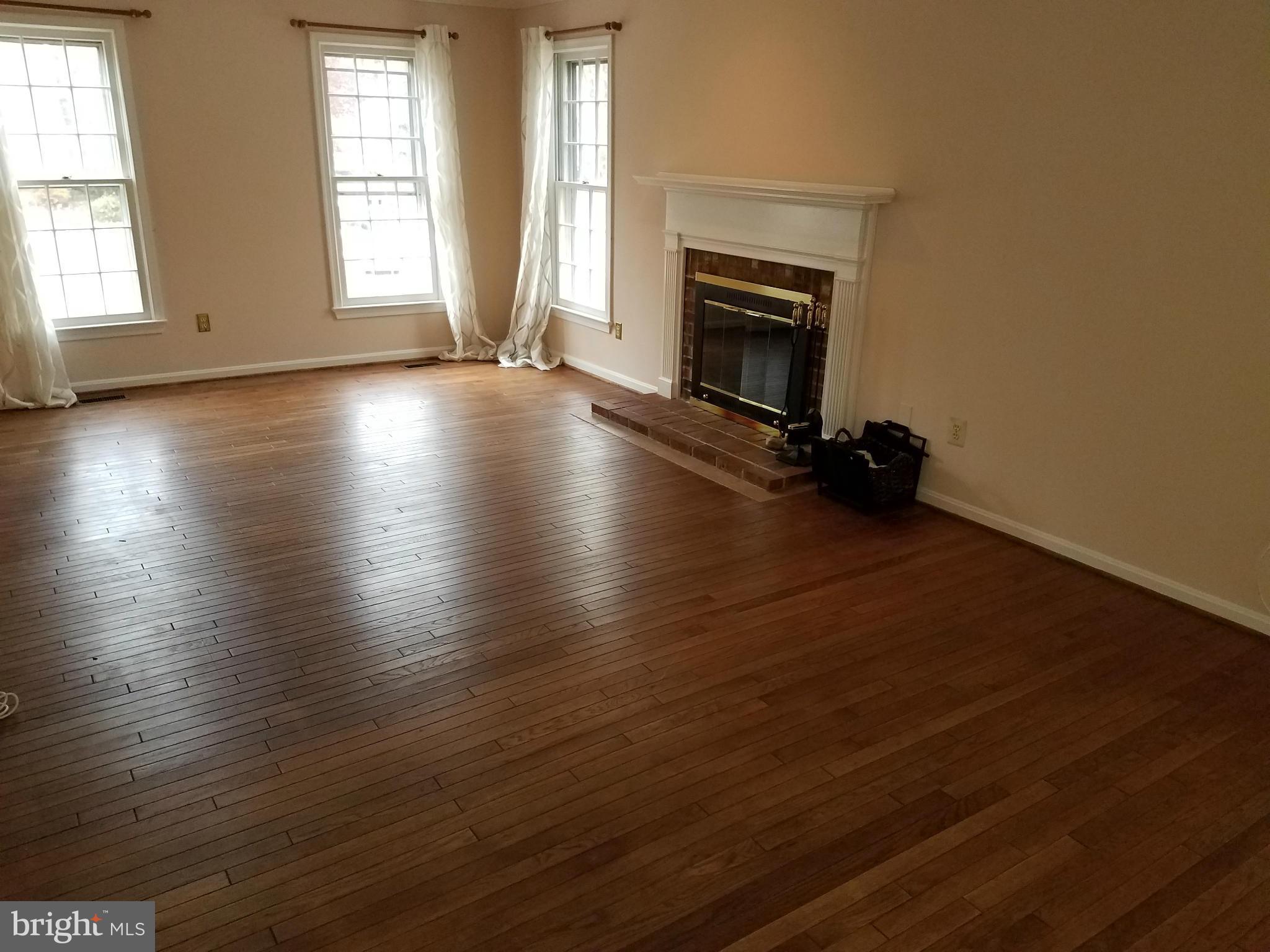 2117 Salt Kettle Way Reston, VA 20191 - Photo 7 of 30 an empty room with wooden floor and fireplace