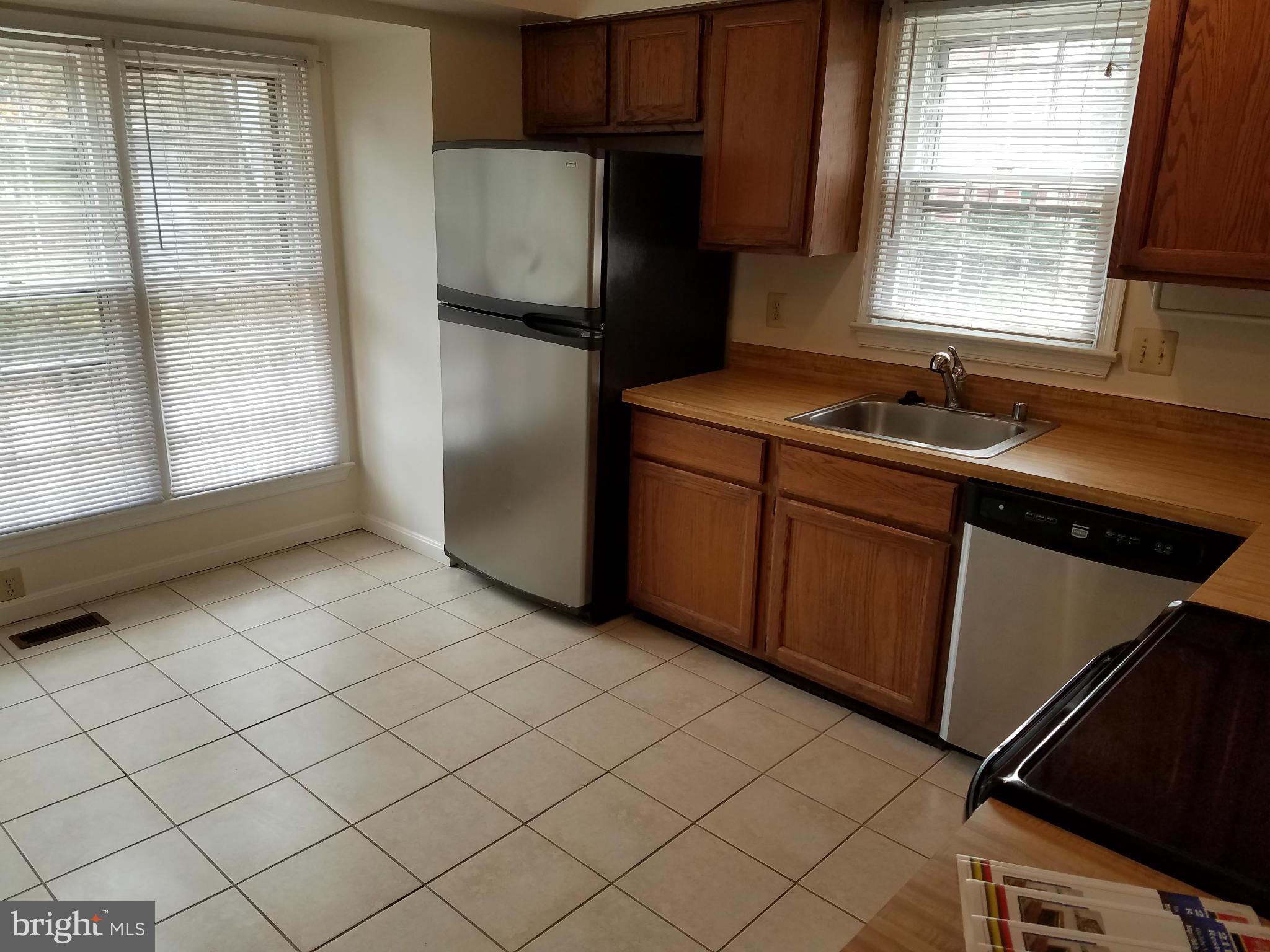 2117 Salt Kettle Way Reston, VA 20191 - Photo 10 of 30 a kitchen with a sink cabinets and window