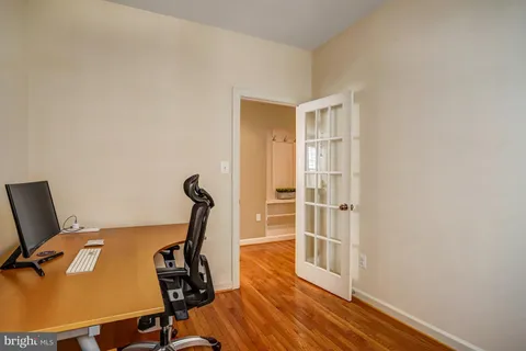 a view of a workspace with furniture and wooden floor