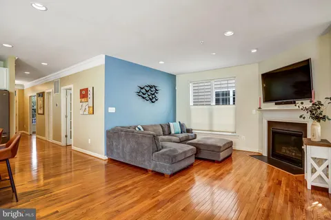 a living room with fireplace furniture and a flat screen tv