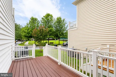 a view of a balcony with chair and wooden floor