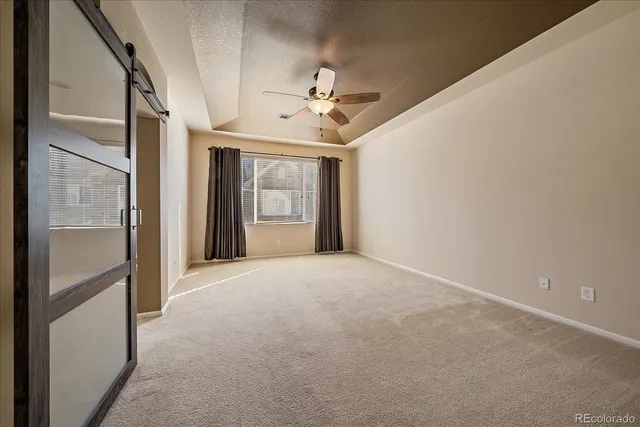 a view of a livingroom with a ceiling fan and window