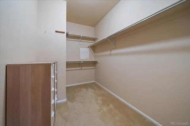 a view of walk in closet with empty racks