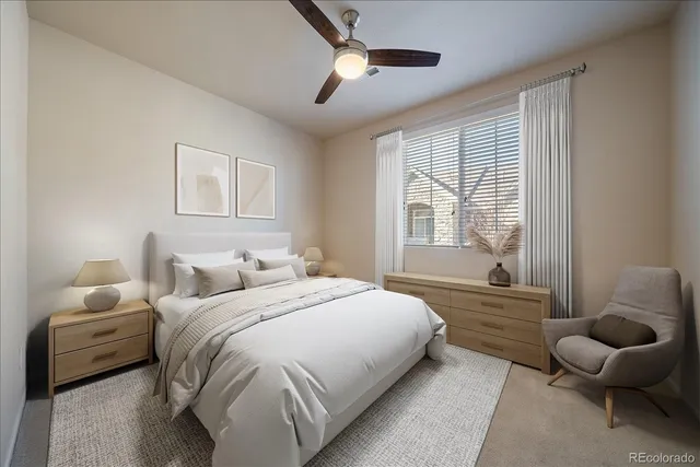 a bedroom with a bed and a large window